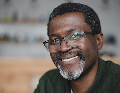 A man smiling after dental implant surgery
