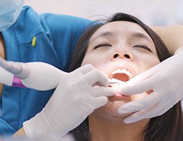 A woman getting a scaling and root planing procedure