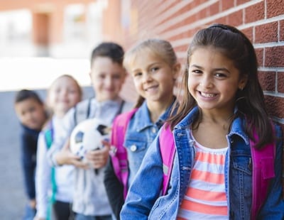 Group of kids with flawless smiles after fluoride treatment