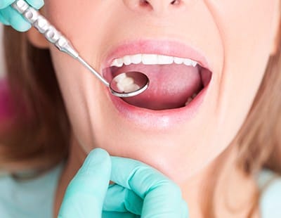 Dentist checking patient's metal free dental restorations