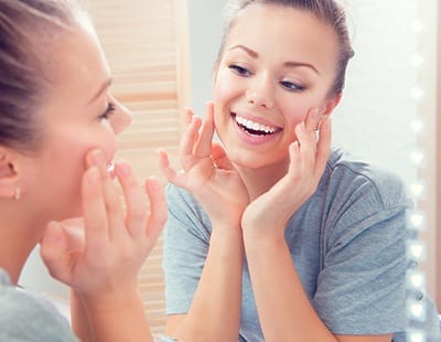 Woman looking at smooth skin after Botox treatment