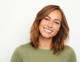 a woman smiling with dentures in Ellicott City