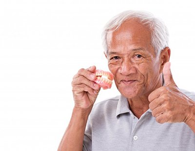 Man with dentures in Ellicott City gives thumbs up