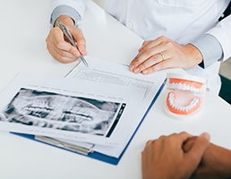 Dentist explaining dental X-ray to emergency patient