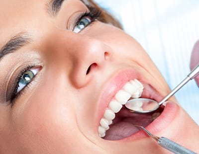 Woman receiving a dental checkup to prevent dental emergencies