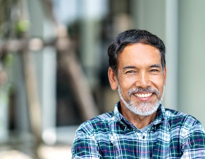 Man smiling with dental implant in Ellicott City