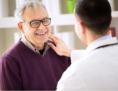 Patient speaking with Ellicott City implant dentist 