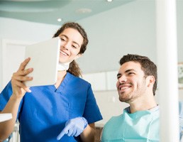 Dentist showing patient image on tablet
