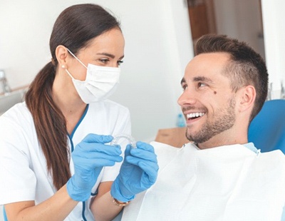 Dentist and patient discussing cost of Invisalign in Ellicott City