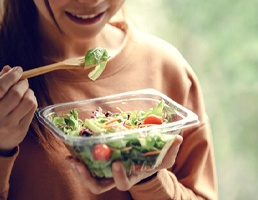 Person eating salad in Ellicott City