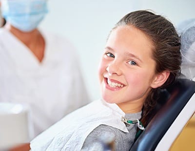 Little girl smiling after fluoride treatment